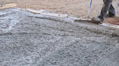 Beton döken işçiler beton döşeme kullanarak zemini alçılıyor.