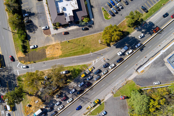 Aerial view of road intersection urban transportation during rush hour with cars moving heavy traffic