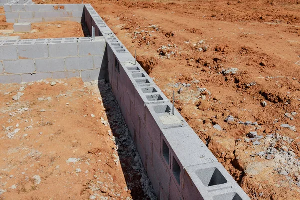 stock image Mounted foundation of cement blocks that will support for wall of house at construction site