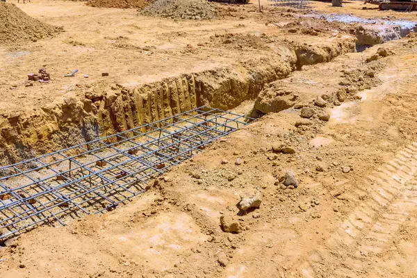 For purpose of pouring concrete deep strip foundation for trench is prepared