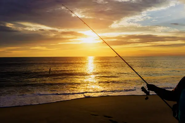 Fishing fish at sunrise in morning at ocean by fisherman