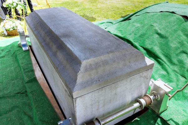 Funeral service with coffin of deceased during ceremony