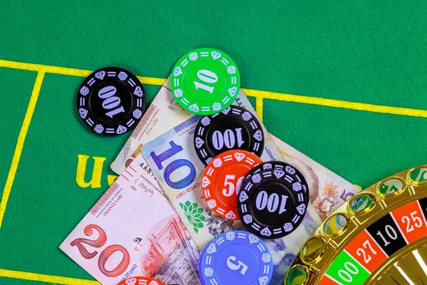 On green gaming table are roulette Georgian banknotes lari poker chips.