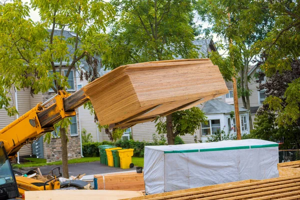 Stock image Lift manipulator unloads material delivered on construction site