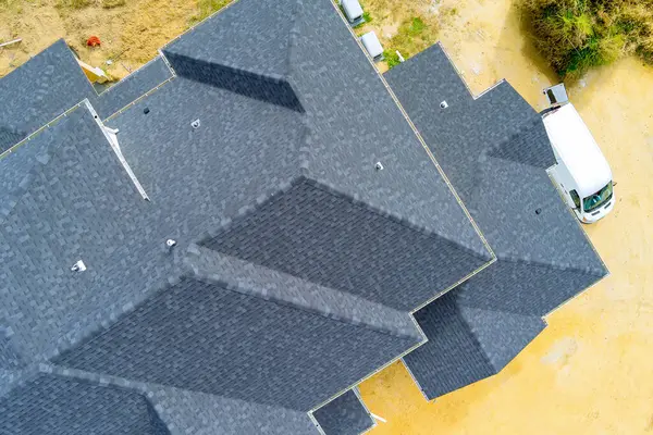 There are asphalt shingles covering roof of newly constructed house
