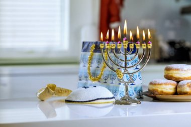 During Hanukkah Jewish religion holiday celebration, Hanukkiah Menorah candlelights clipart