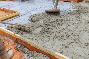 Beton, inşaat işçisi tarafından özel araç kullanılarak dengelenir