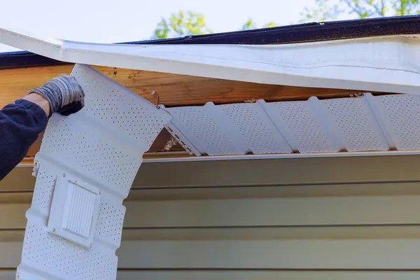 stock image Master makes repairs after hurricane damages fascia trim