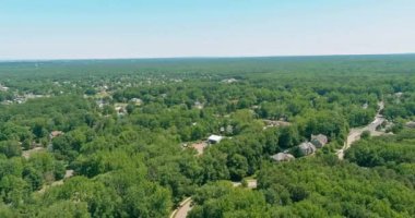New Jersey American town with different built houses in suburbs between forest areas