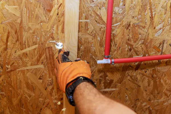 stock image Installing connecting PVC plastic water pipes to walls of home