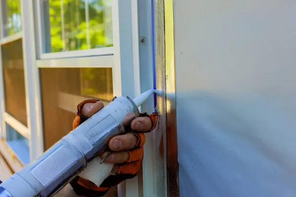 stock image After installation of windows, seams are coated with silicone stripping seal