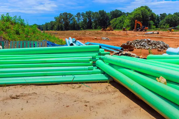 stock image On construction site there are green PVC pipes used to lay pipe water system for new house