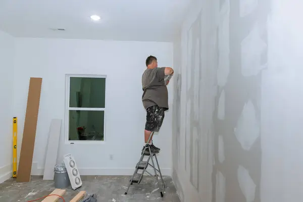 stock image Worker plasterers plasterboard walls in new room