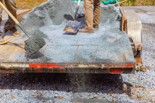 stock image During leveling of driveway, workers filled parking lot near house with small stones