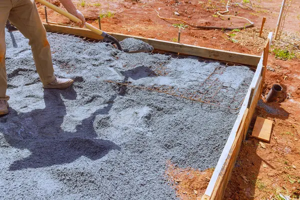 stock image For purpose of pouring concrete into foundation for house, ground is leveled filled with fine gravel stones