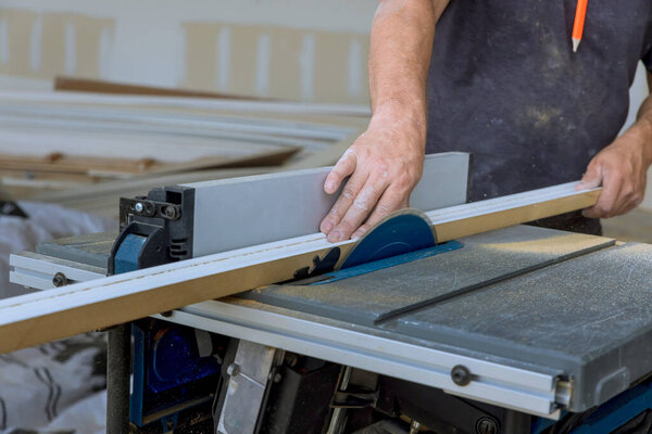 Table saw powered by electricity is used to cut wood molding filler
