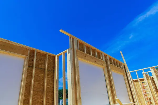 stock image Building frame for unfinished interior timber support beams during construction of new building