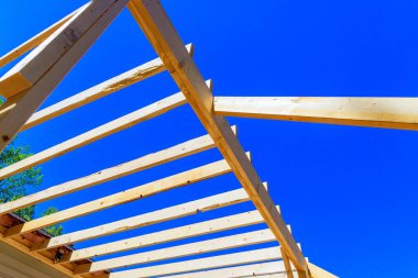 Ev inşaatının geliştirilmesinin bir parçası olarak, çerçeve kirişleri ahşap kirişleri tamamlanmamış bir zemine yerleştiriliyor