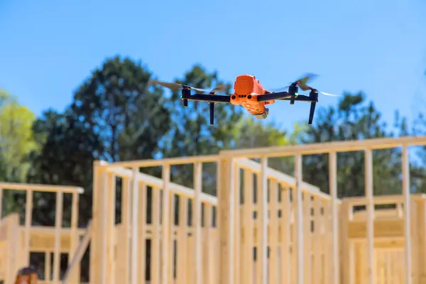 stock image With aid of drone, supervisor of the contractor inspects t work on construction site.