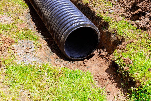 Поток воды будет направляться через пластиковые черные трубы в систему сбора дождевой воды