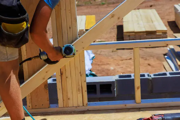 Stock image Framing contractor uses an air nails hammer worker nailing wooden beams