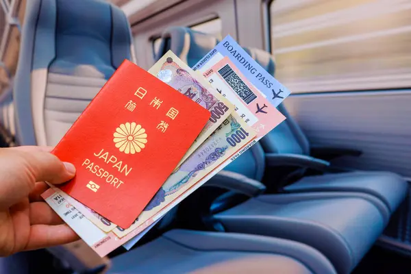stock image Passenger is holding Japanese yen banknote Japan passport, as well as tickets for train transfer to airport