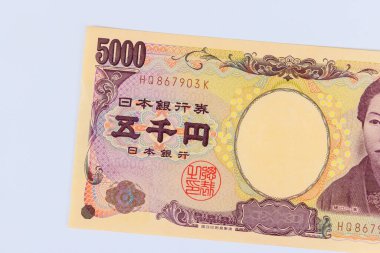 At Japan, Japanese yen currency banknotes are issued by Nippon Ginko Japan National Bank in denominations of five thousand yen front view clipart