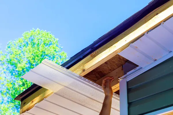 stock image In new house, employee installed vinyl soffit plastic panels on facade ceiling