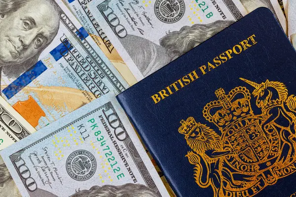 stock image With newly introduced biometric British passport, US currency dollars notes, United Kingdom of Great Britain is symbolizing transatlantic relationship with its citizens