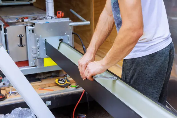 stock image Installing hidden gutter hangers using pre inserted screw to attach new gutters to roof