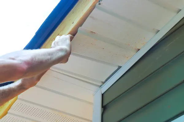 stock image Member of staff installed vinyl soffit panels on facade ceiling new house