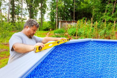 Assembling of construction ground swimming pool at house in back yard clipart