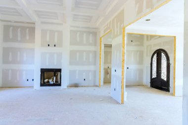 Walls ceilings of interior of new house are plastered ready for paint priming clipart