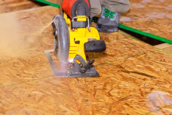 stock image Circular saw being used by worker to cut plywood