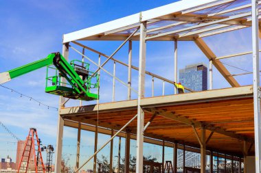 Steel beams frame an office building during construction clipart