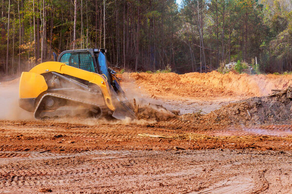 Leveling ground with bulldozer on construction site prior to grading soil