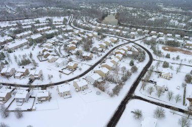 Aerial view of American suburbs in winter, showing houses, streets, covered in snow. clipart