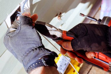 Elektrikçi müteahhiti evin dış cephesine elektrik prizleri kuruyor