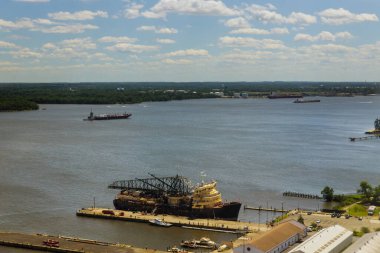 Ships, boats are docked at bustling port, reflecting activity on scene features variety of vessels scenic view of landscape clipart