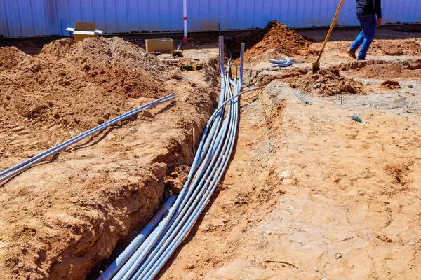 İşçiler, vakıf işi sırasında inşaat sahasındaki hendekte elektrik hatları düzenliyor