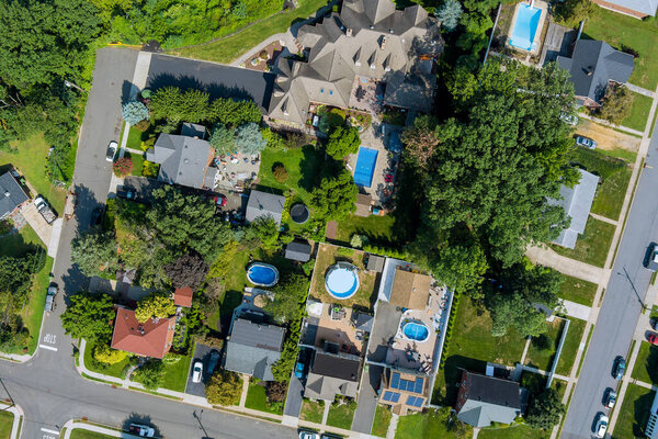 Birds eye view of suburban neighborhood showcasing houses with pools, gardens, landscaped yards at Sayreville American town New Jersey