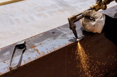 İş gününün altında endüstriyel bölgede uçuşan kıvılcımlarla kaynaklı metal kesimi oluşuyor.