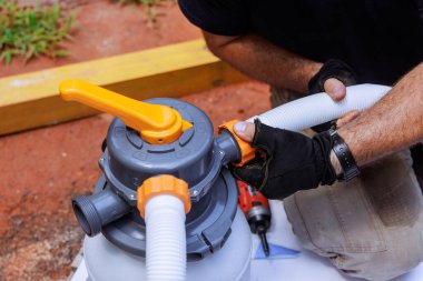 Yüzme havuzunda çalışırken eller hortumu pompa sistemi temizleme eklentisine bağlar