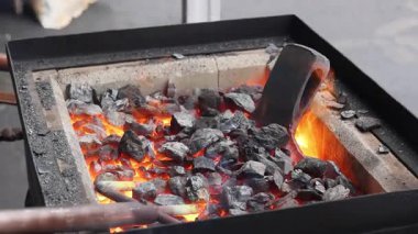 Metal, demirci dükkanında parlayan kömürlerden kıvılcımlar uçuşurken, baltayla ustalıkla işçilik yapılırken şekilleniyor..