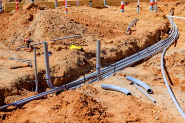 İnşaat alanı döşeme kanallarıyla, elektrik borularıyla, matkap endüstriyel araç gereçleriyle dolup taşıyor..