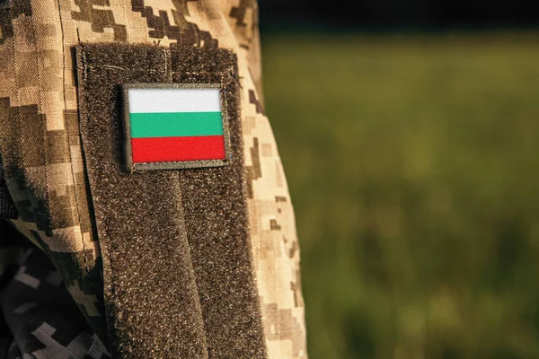 Close up millitary woman or man shoulder arm sleeve with Bulgaria flag patch. Bulgaria troops army, soldier camouflage uniform. Armed Forces, empty copy space for text