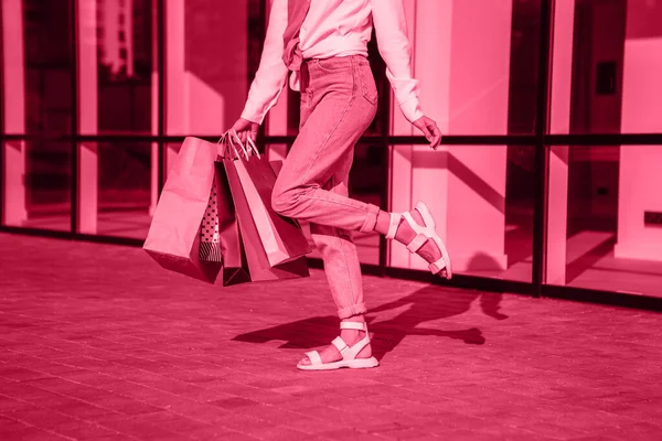 stock image Viva Meganta toned red magenta european woman hold bags after shopping, retail store mall on the street sales black friday season. Trendy color of the year 2023. Fashion color pattern