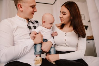 Little boy pop-eyed surprised cute child baby looking at mother breast. Playful shocked toddler with bulging big eyes having fun, making faces grimaces. Happy childhood, family concept