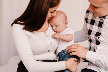 Little boy pop-eyed surprised cute child baby looking at mother breast. Playful shocked toddler with bulging big eyes having fun, making faces grimaces. Happy childhood, family concept