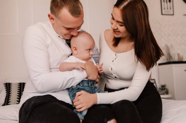 Little boy pop-eyed surprised cute child baby looking at mother breast. Playful shocked toddler with bulging big eyes having fun, making faces grimaces. Happy childhood, family concept
